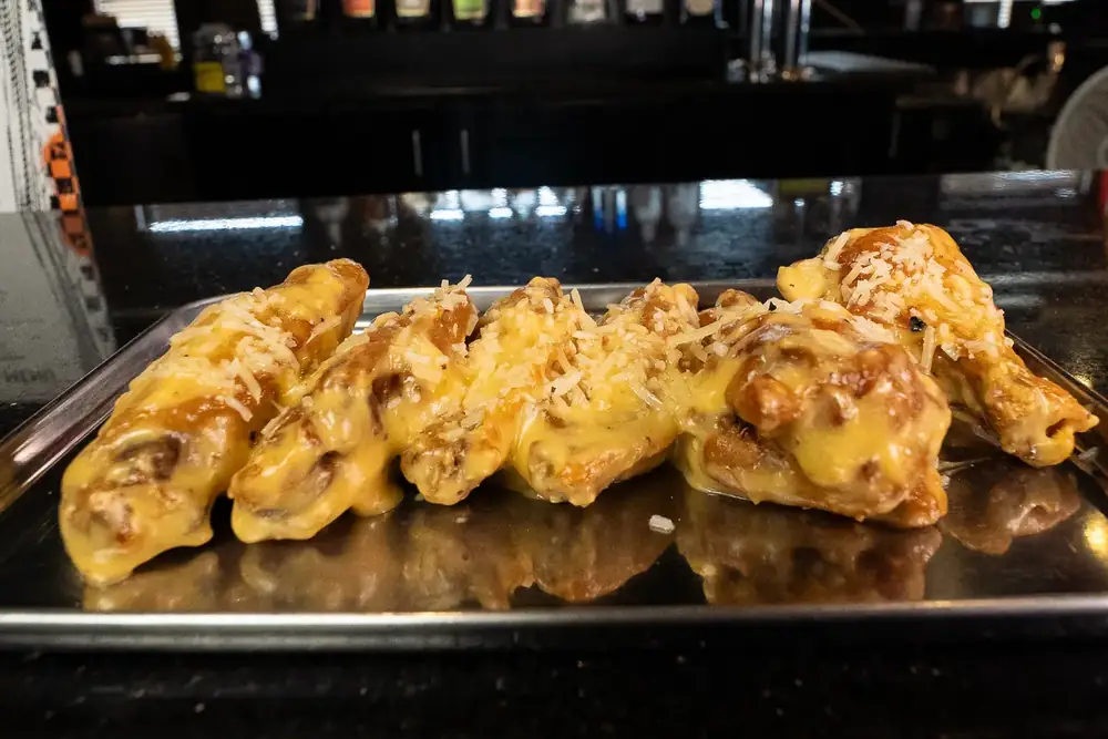 A tray of garlic parmesan wings at 212