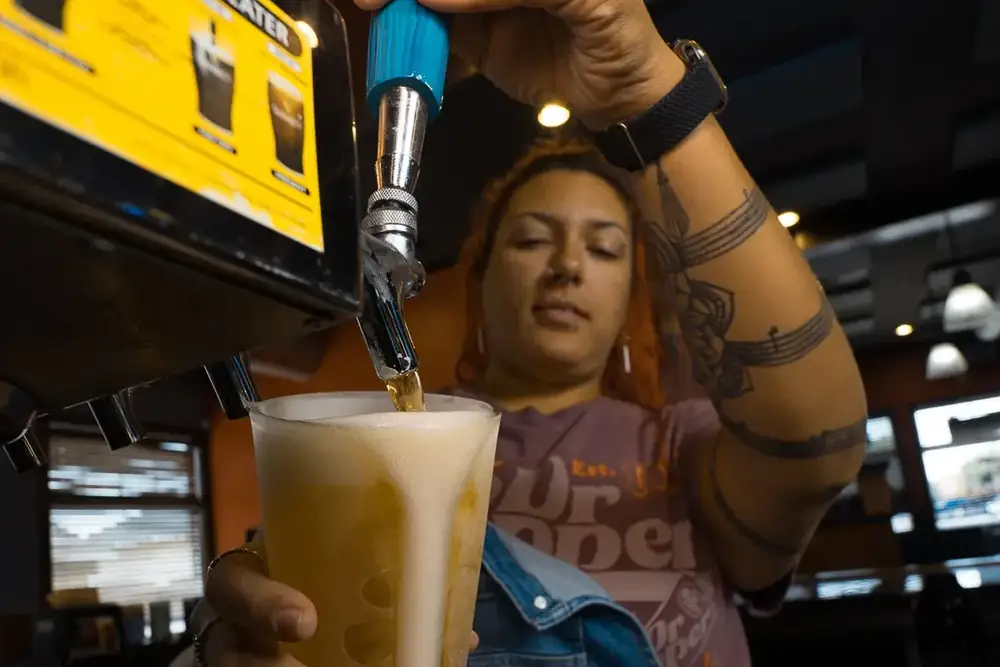 Pouring a cold draft beer behind the bar at 212 The Boiling Point