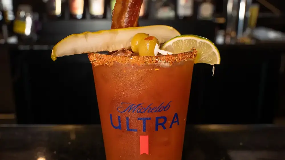 A loaded bloody mary garnished with bacon and a lemon wedge from the 212 drink menu