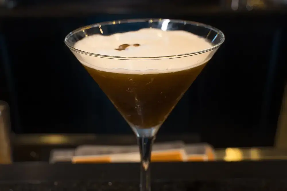 An espresso martini on the granite bar top at 212
