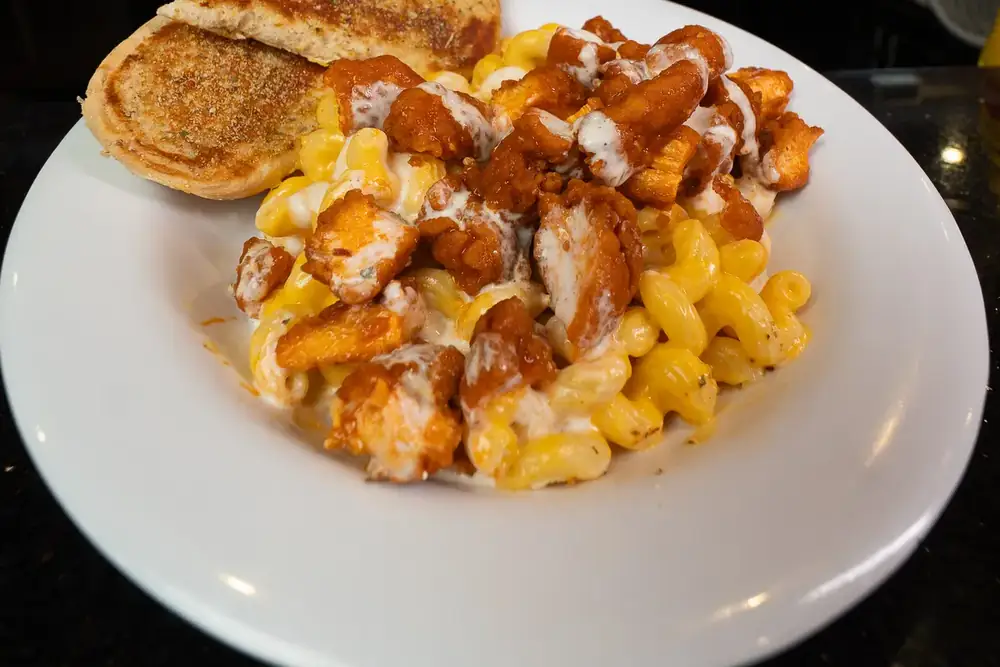 Buffalo chicken mac and cheese with Texas toast on a white plate at 212