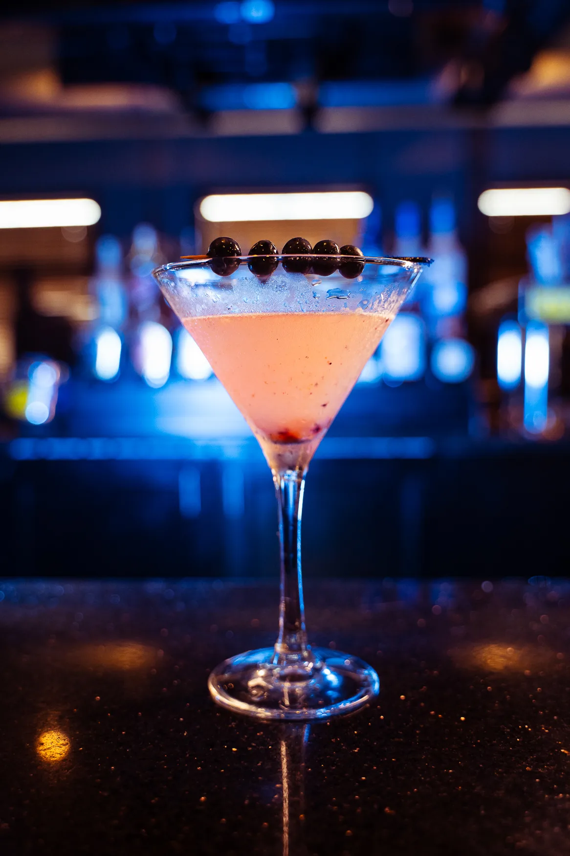 A pink martini glowing under the bar lights at 212 A pink martini glowing under the bar lights at 212