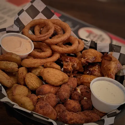Appetizer sampler with onion rings, cheese curds, fried pickles and wings