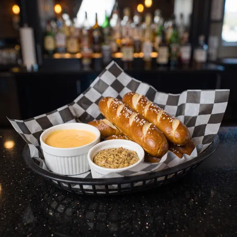 Pretzel Rods at 212 The Boiling Point: 4 soft pretzel rods served with house made cheddar sauce and whole grain mustard