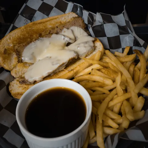 Brisket French Dip with provolone, a side of au jus and fries