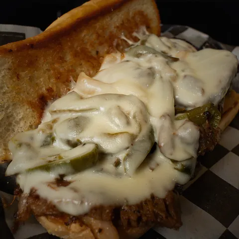Brisket Philly piled with peppers, onions and melted provolone