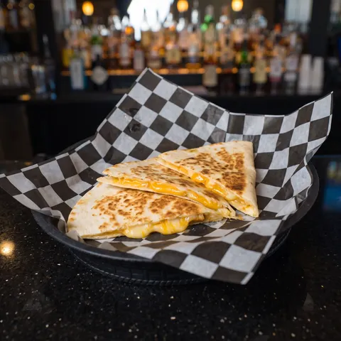 Kids Cheese Quesadilla at 212 The Boiling Point: A small toasted flour tortilla cheese quesadilla cut into three wedges, melted cheddar at the edges, 