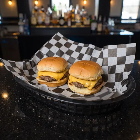 Kids Cheeseburger Sliders at 212 The Boiling Point: Exactly two small cheeseburger sliders on mini buns, each with a beef patty and a slice of melted 