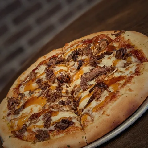 The Pit Daddy pizza with house smoked meats and a BBQ drizzle