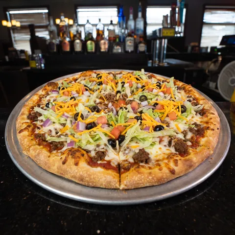 Taco at 212 The Boiling Point: Taco sauce base, taco seasoned beef, mozzarella cheese, topped with shredded lettuce, diced onions, black olives, tomat