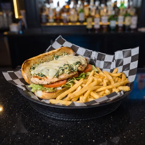 Spinach and Artichoke Chicken at 212 The Boiling Point: Grilled chicken breast, house made spinach and artichoke dip, provolone, lettuce, and tomato