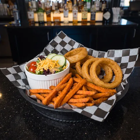 Premium Sides at 212 The Boiling Point: A sampler of PREMIUM SIDES arranged together: a small pile of sweet potato fries, a stack of golden onion ring