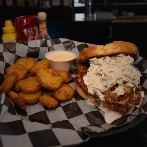 The Slawppy Pig, pulled pork topped with coleslaw, with fried pickle chips