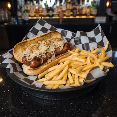 Smoked Sausage at 212 The Boiling Point: German style jalapeno and pepper jack cheese sausage split, seared and topped with sauerkraut and whole grain