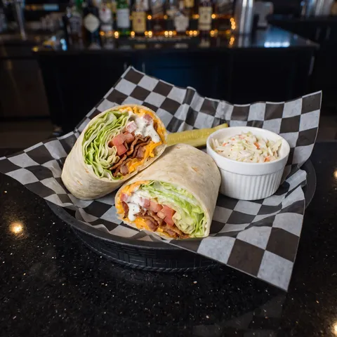 BLT at 212 The Boiling Point: Bed of iceberg lettuce with hickory bacon, tomato, shredded cheddar, and a ranch drizzle in a flour tortilla
